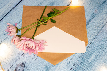 postcard envelope wooden table and chrysanthemums