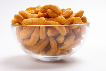 Deep fried battered onion pakoda slightly curly crispy spicy ready to eat snack
