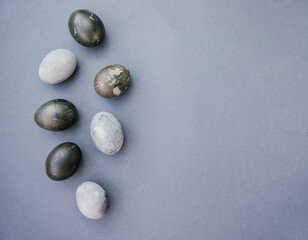 Easter greeting card with a place for text. Easter Background. Handmade colored Eggs on a Gray background.