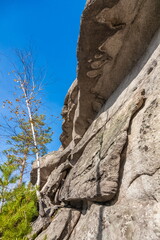 Autumn landscape with trees and rocks on top of a mountain against the sky