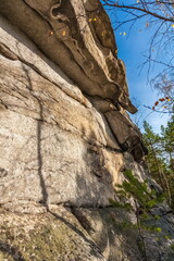 Autumn landscape with trees and rocks on top of a mountain against the sky