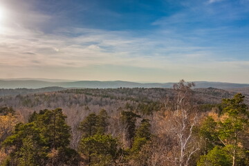 Autumn landscape from the top of a mountain with forest and sky