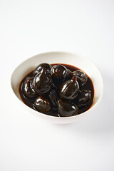 Caramelized figs with cheese a typical Ecuadorian desert, served on a traditional plate on a white background