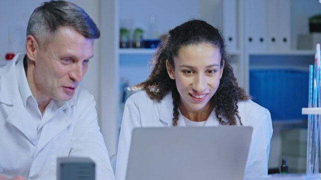 Successful lab scientists happy with innovative medicine testing result teamwork