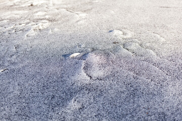 Black soot from the boiler room on white snow. Natural background. Snow mixed with coal soot, poor ecology. Environmental pollution 