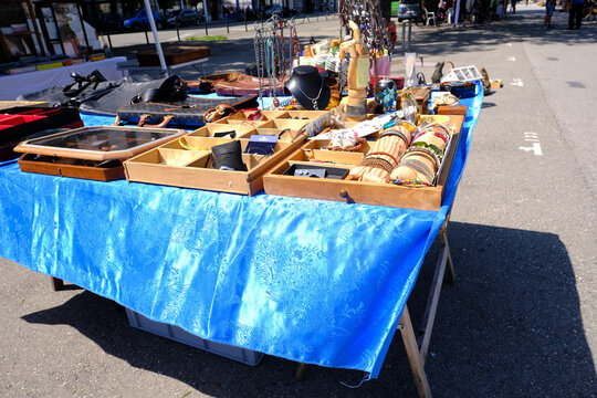 flea market flip in the city, antiques, old furniture, tables, used things, clothes and other goods are sold on the street, recycling of unwanted items, pollution of nature