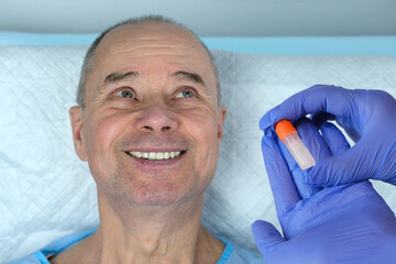 mature man, doctor's hands takes saliva sample, biological material for DNA, pathologies, viruses,...