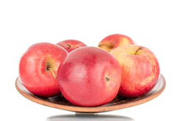 Several juicy, ripe, red apples on a plate of clay, macro, isolated on a white background.
