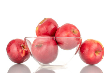 Several juicy, ripe, red apples with glassware, macro, isolated on a white background.
