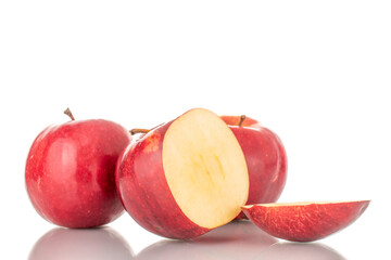 Fototapeta na wymiar Two whole and one with a cut off piece of juicy, organic, red apples, macro, isolated on a white background. 