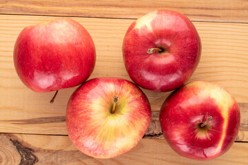 Some sweet organic, red apples  on a wooden table, macro, top view.