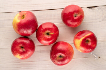Some sweet organic, red apples  on a wooden table, macro, top view.
