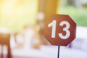 13 - thirteen, the number of the table in the restaurant. unlucky or lucky number, blur soft focus