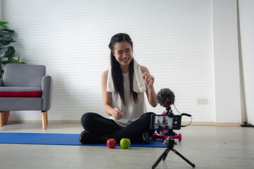 Fototapeta na wymiar young Asian woman are live streaming about healthy food and sport health lifestyle in studio, diet female are happy to recording online social media