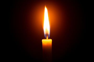 One light candle burning brightly in the black background 