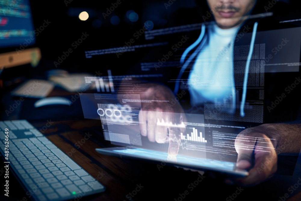 Poster Your network has been breached. Shot of an unidentifiable hacker using a digital tablet in the dark.