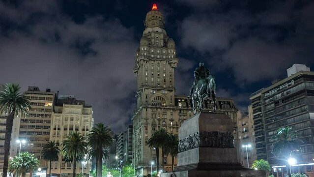 Montevideo, Uruguay, zoom out time lapse view of Independence Square showing historic landmark Artigas Mausoleum at night in the Old Town district of Montevideo.