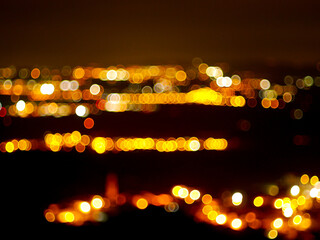 Glowing lights from a city in Spain in the night blurred background