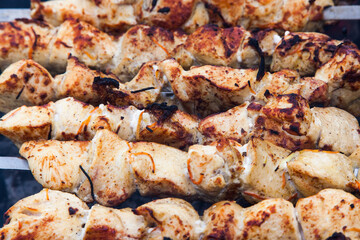 The meat is grilled on a grid over charcoal close-up.