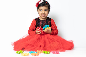 Happy Indian Pretty Girl Playing With Colorful Toys On White Background. Fun, Activity, Educational, Kindergarten, Birthday, Learning, Home Activity, School, Nursery, Daycare, Development Concept