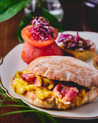 tasty egg and bacon brunch sandwich pita with tomato