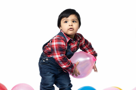 Happy Asian Indian Toddler Boy Playing With Balloons. Fun, Activity, Pre School, Educational, Kindergarten, Birthday, Learning, Home Activity, School, Nursery, Daycare, Play, Physical Activity Concept