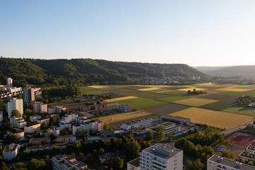 Amazing shot of a beautiful landscape in the alps of Switzerland. Wonderful flight with a drone over an amazing landscape in the canton of Aargau. Epic view at sunset over a village called Nussbaumen.