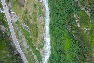 Amazing shot of a beautiful landscape in the alps of Switzerland. Wonderful flight with a drone over an amazing landscape in the canton of Bern. Epic view over a river.