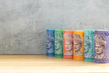 Malaysian Currency, Rolls of Money, Ringgit Notes lined up according to value, Place for text