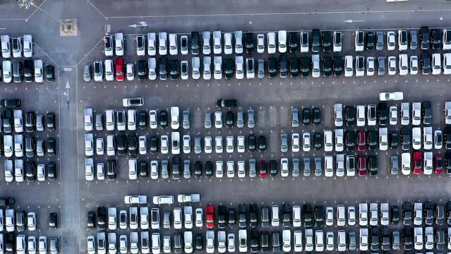 Aerial view from bottom to top New cars are produced from a car factory parked in a large number of parking lots to prepare for export abroad