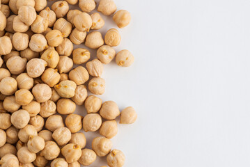 Food background with a layer of chickpeas on white