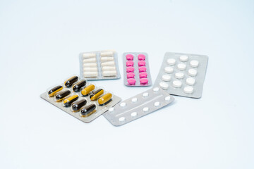 Medical pills and capsules in a blister pack isolated on white background
