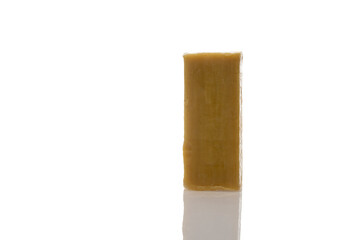 a piece of household soap of 72 percent fat content, highlighted on a white background, reflection. Cleanliness, disinfection and health. Close-up. Natural soap for washing.