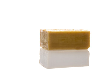 a piece of household soap of 72 percent fat content, highlighted on a white background, reflection. Cleanliness, disinfection and health. Close-up. Natural soap for washing.