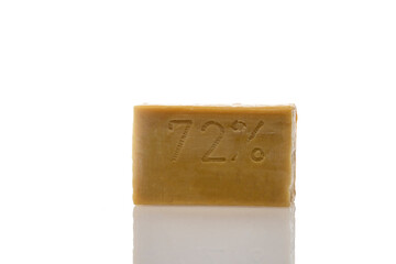a piece of household soap of 72 percent fat content, highlighted on a white background, reflection. Cleanliness, disinfection and health. Close-up. Natural soap for washing.