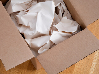 Crumpled paper in a cardboard box