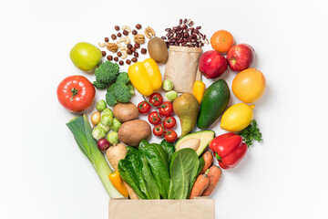 Obraz na płótnie Canvas Healthy food background. Healthy food in paper bag vegetables and fruits on white. Shopping food supermarket concept. Food delivery, groceries, vegan, vegetarian eating. Top view