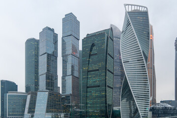 Fototapeta premium Skyscrapers in the center of Moscow on a cloudy day. High-rise buildings in the capital of the Russia. Complex Moscow-city against the gray sky.