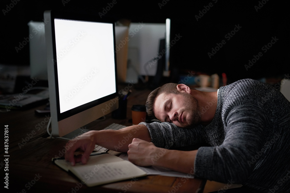 Poster Ill just rest my eyes for a moment. Shot of a tired computer programmer sleeping at his desk.