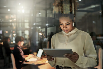 Shes taking the lead on this project. Shot of an attractive young designer working late at the...