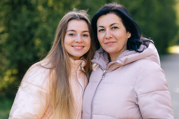 Portrait of mother and her teenage daughter outdoor in nature