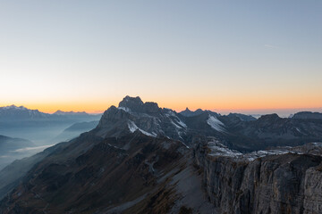 Fototapeta na wymiar Amazing shot of a beautiful landscape in the alps of Switzerland. Wonderful flight with a drone over an amazing landscape in the canton of Glarus. Epic view at sunset.