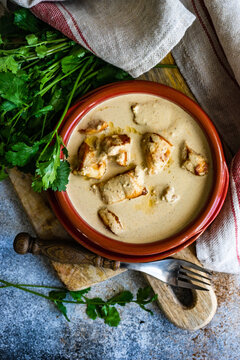 Overhead view of a bowl of Georgian chicken in walnut sauce (Chicken Bazhe) with coriander
