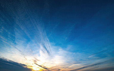 blue sky with spindrift clouds at sunset