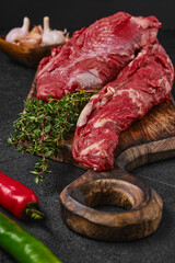 Closeup view of raw beef whole tenderloin on black background