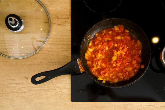 Overhead View Of Frying Pan With Tomato Sauce On Modern Electric Stove