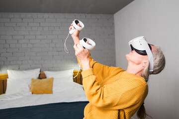 virtual reality. VR, future, gadgets. senior woman playing game in virtual reality glasses and...
