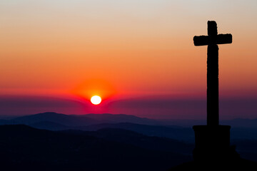Crucifix silhouette at Sunset during the Holy Week in Sao Mamede Mountain, Povoa de Lanhoso, Braga, Portugal. 