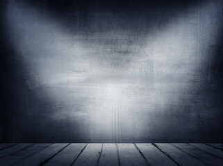 Empty wooden floor and blank blue concrete wall in spotlit light interior garage studio room. Copy space or product display.