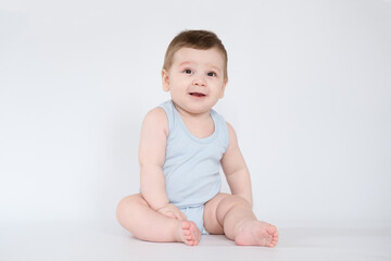 child baby boy sitting happy smiling boy on a white 7 month background